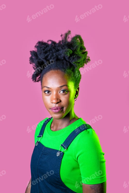 Preview: Studio portrait young black woman looking camera positive and contemplative