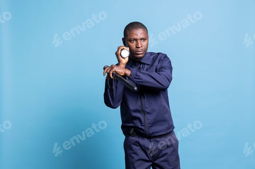 Preview: Security guard patrolling the premises with a flashlight and baton