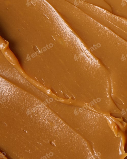 Preview: Vertical closeup shot of a smooth creamy brown peanut butter surface