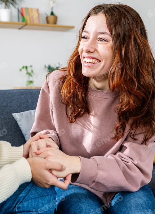 Preview: Affectionate Couple Holding Hands on Couch at Home