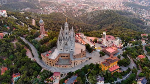 Preview: Aerial view of Tibidabo, Barcelona city skyline with Sagrat Cor temple at sunrise. Catalonia, Spain