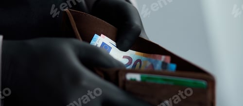 Preview: Man holding a wallet with money euro in hand in black medical gloves.