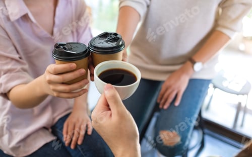 Preview: Closeup of a group of young people enjoyed drinking and clinking coffee cups together in cafe