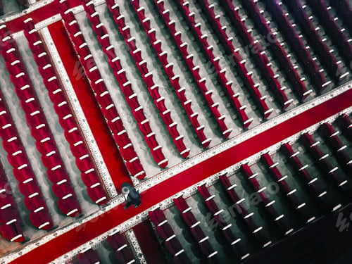 Preview: Overhead View of a Tiny Human Walking Among Many Rows of Red Chairs