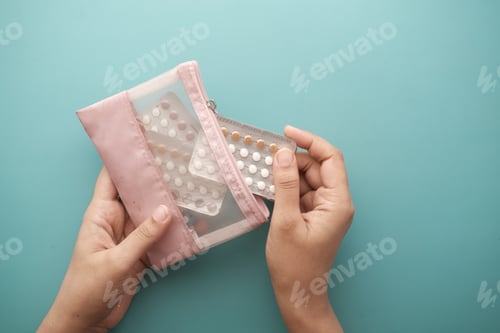 Preview: women hand holding birth control pills close up