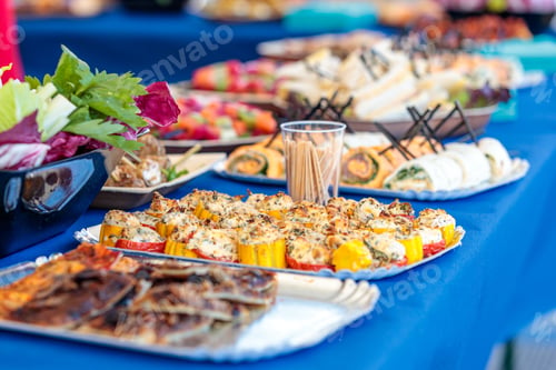 Preview: High angle shot of delicious desserts and appetizers on a table in a yacht