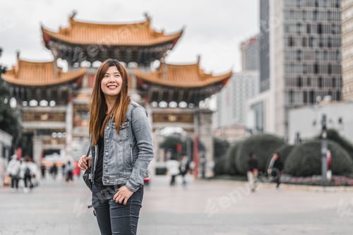 Preview: Asian traveler woman looking and sightseeing when travelling over the Jinbi square, Kunming, China,