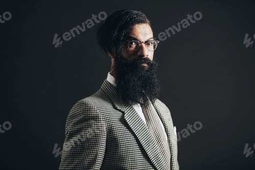 Preview: Close Up Portrait Of A Serious Formal Guy With Long Goatee Beard Looking At Camera On A Black