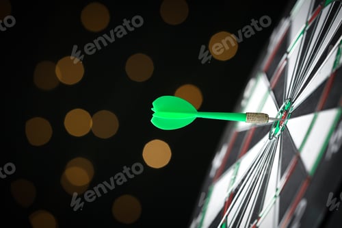 Preview: Green arrow hitting target on dart board against blurred lights. Space for text