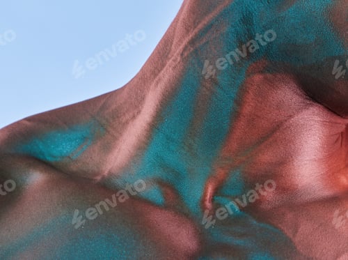 Preview: Even tough people have weak spots. Shot of a muscular man posing against a studio background.