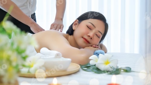 Preview: Attractive young beautiful asian woman in spa salon is having massage.