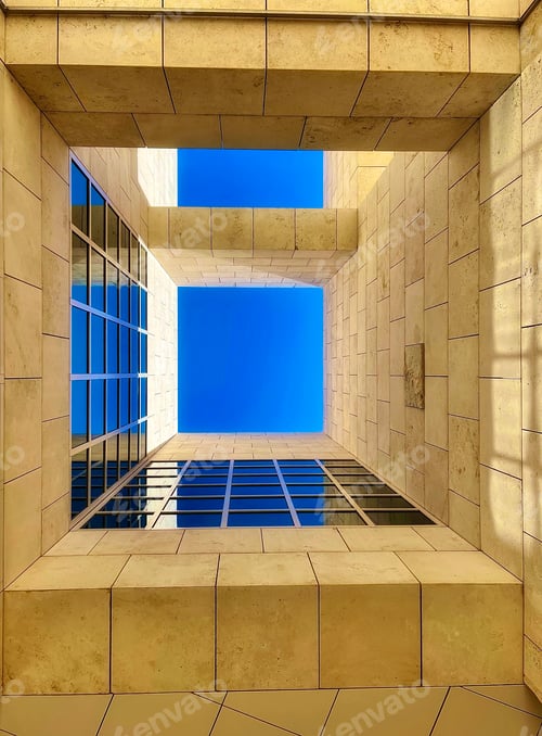 Preview: A view of the clear blue sky surrounded by windows from the ground floor of a futuristic building.