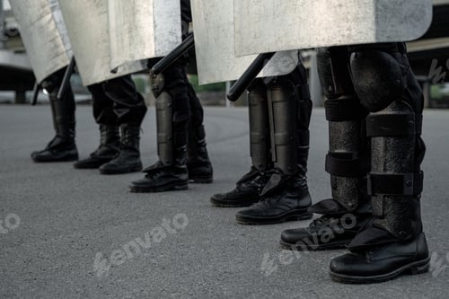 Preview: Legs of riot police at street