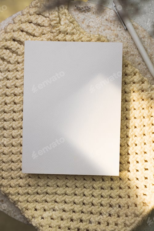 Preview: mockup paper poster card on wicker bag with sunlight on table