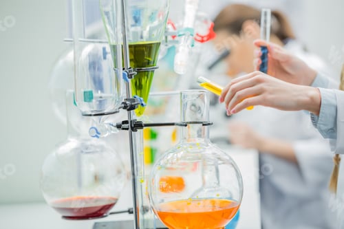 Preview: Close-up partial view of female scientist working with reagents in chemical laboratory