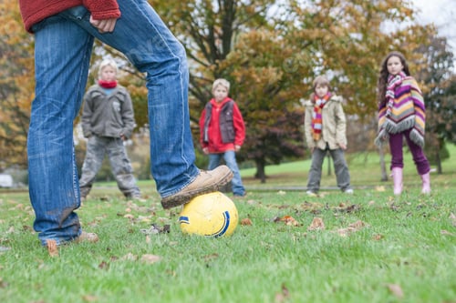 Preview: Father and children, playing football in park