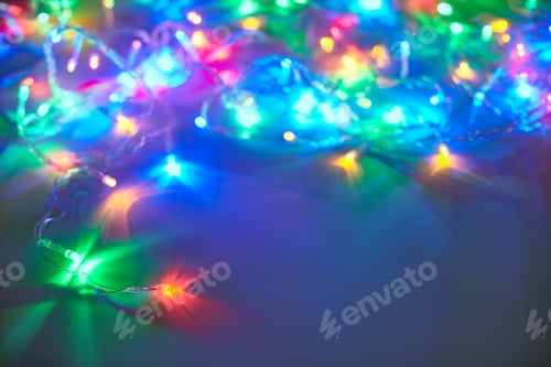 Preview: Christmas lights on dark blue background with copy space