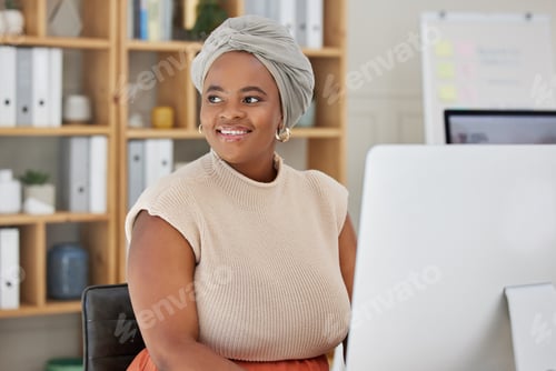 Preview: Young african american businesswoman with a headscarf sitting alone in an office and thinking while