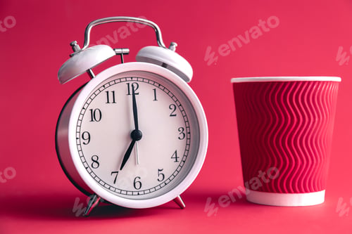 Preview: White stylish alarm clock and paper cup, morning concept.