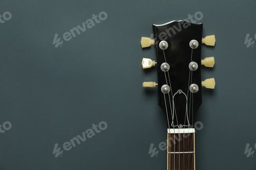 Preview: Electric guitar neck on dark background, space for text