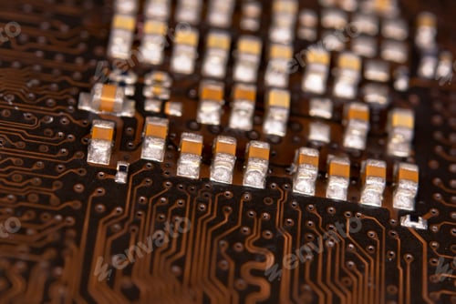 Preview: close up ceramic capacitors on electronic circuit board