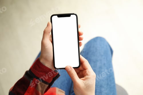 Preview: Woman in shirt and jeans holding phone with empty screen