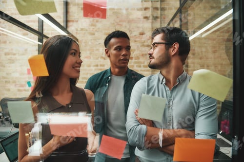 Preview: Multicultural team. Cheerful male and female colleagues planning working process and using colorful