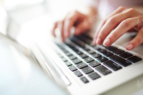 Hands Typing on a Silver Laptop Keyboard