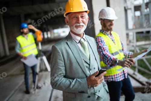 Preview: Engineer and construction site manager dealing with blueprints and plans