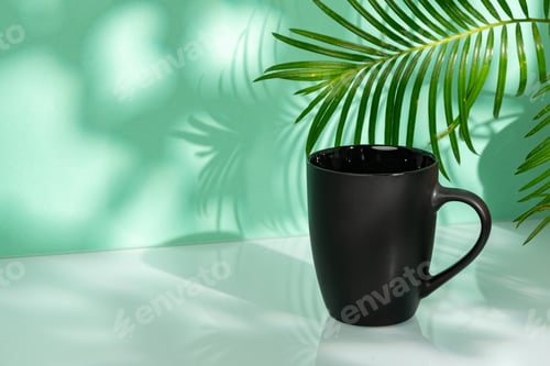 Preview: Porcelain mug and palm leaf against mint background