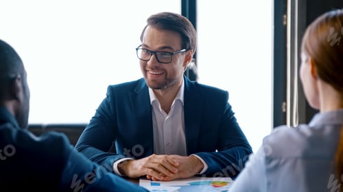Preview: Business team discussing a project at a meeting