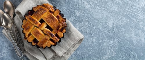 Preview: Homemade open cherry pie with lattice on a gray concrete background. Selective focus. Top view