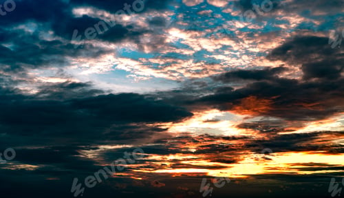 Preview: Beautiful sunset sky. Orange, blue, and white sky. Colorful sunset. Art picture of sky at sunset.