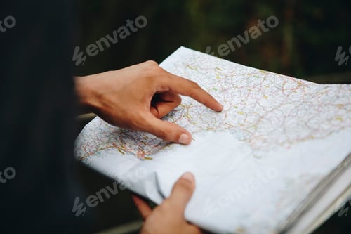 Preview: Caucasian man looking at a map travel and explore concept