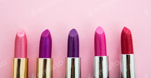 Preview: Lipsticks various colors against pink background, closeup view