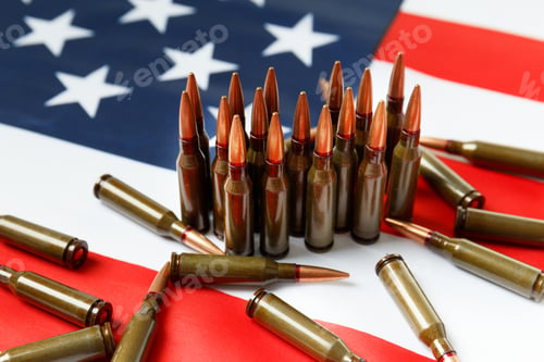 Preview: Bullets for firearms, combat army cartridges on the American flag.