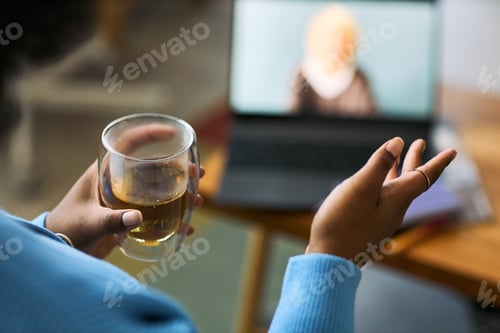 Preview: Young Adult Black Woman Holding Tea While Video Chatting About Health Online