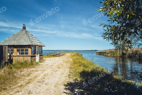 Preview: Beautiful landscape with a lake and unusual clouds in the blue sky.