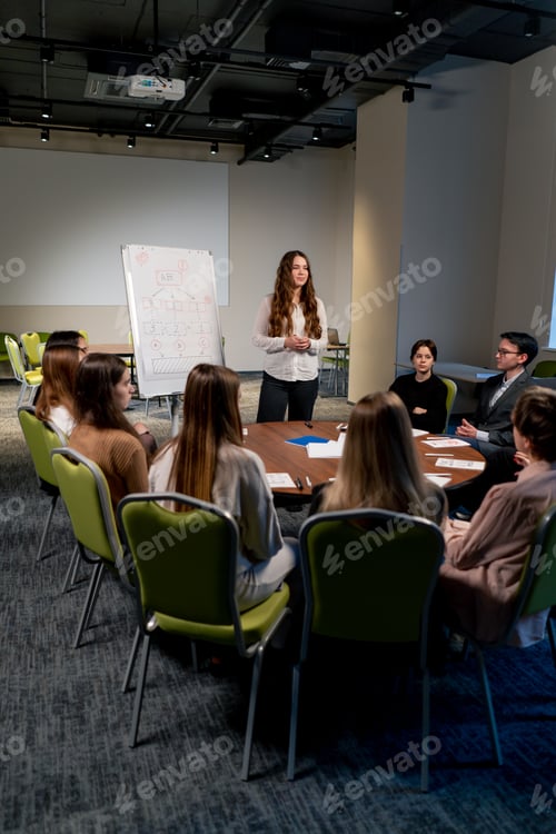 Preview: business conference or meeting at the hotel the girl on the flipchart shows the development plan