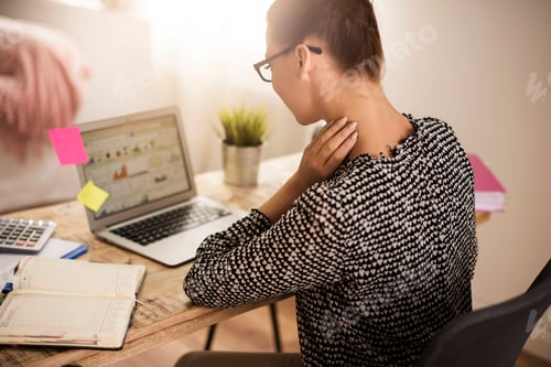 Preview: Rear view of busy woman at the desk