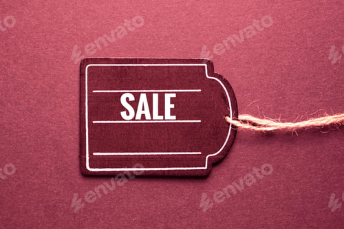 Preview: Closeup of a red price tag on a red surface for a copyspace