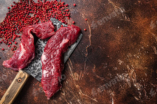 Preview: Raw Machete steak and flap steak flank cut on butcher meat cleaver. Dark background