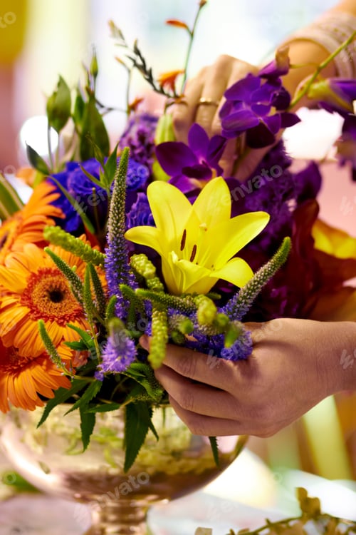 Preview: Bouquet of beauty. Closeup shot of a florists hands arranging a colourful bouqet.
