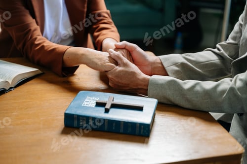Preview: Two people reading and study bible in home and pray together.Studying the Word Of God