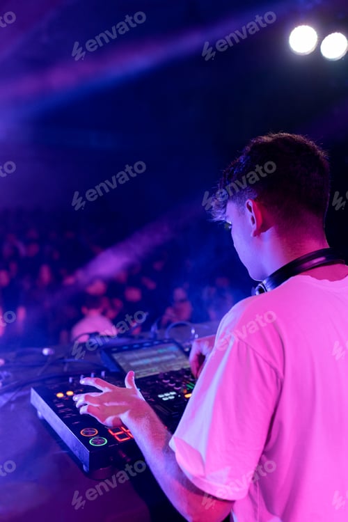 Preview: A DJ mixing on stage using board