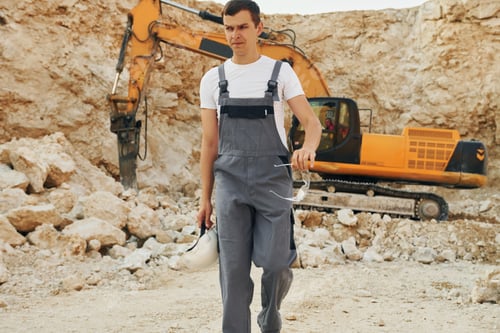 Preview: Operator is working on the borrow pit. Man in professional uniform
