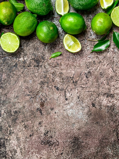 Preview: Pieces of ripe lime and a whole fresh lime.
