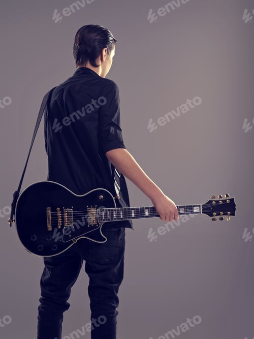 Preview: Guitarist with a black electric guitar. Rear view