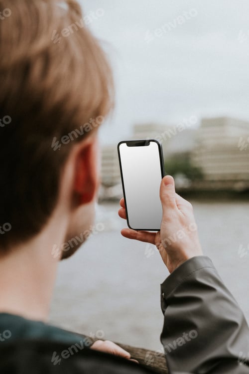 Preview: Man looking at a blank smartphone screen