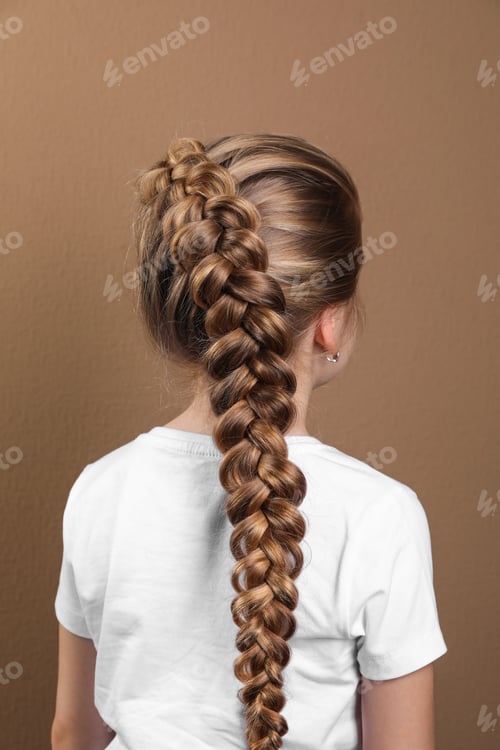 Preview: Little girl with braided hair on light brown background, back view